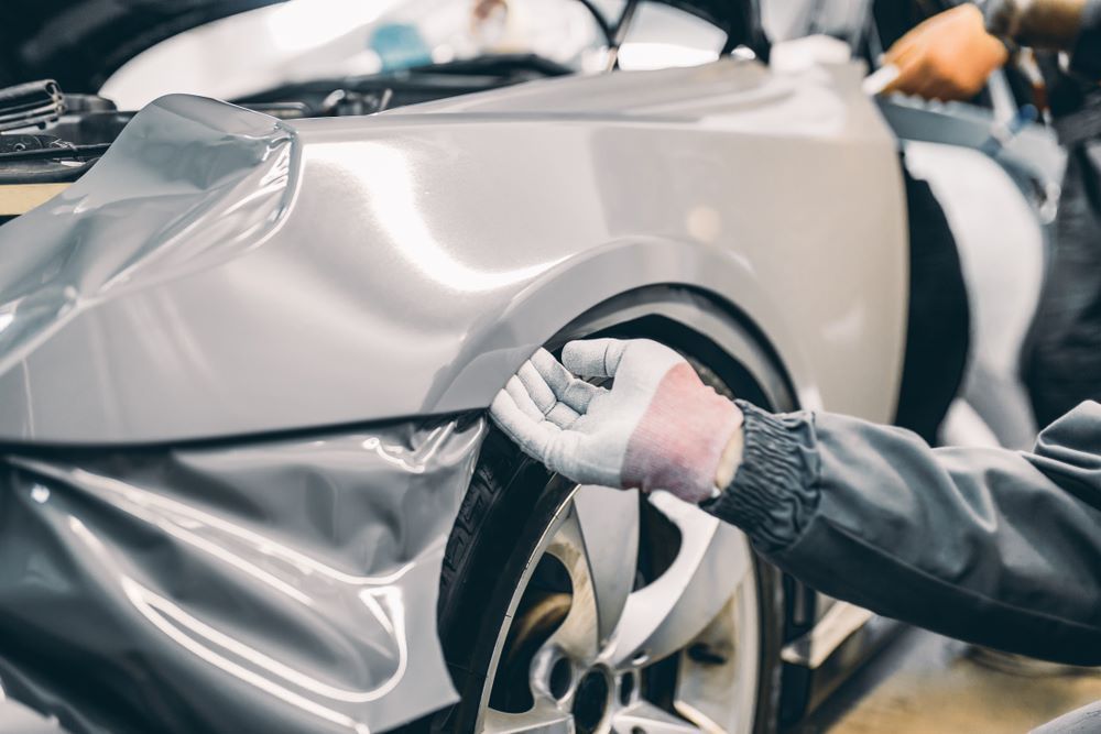 A Man is Wrapping a Car With Aluminum Foil β Vanderpoel Smash Repairs in Tuggerah, NSW
