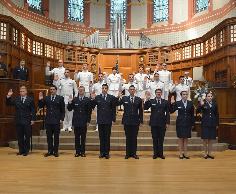 A group of people standing in a church taking oaths