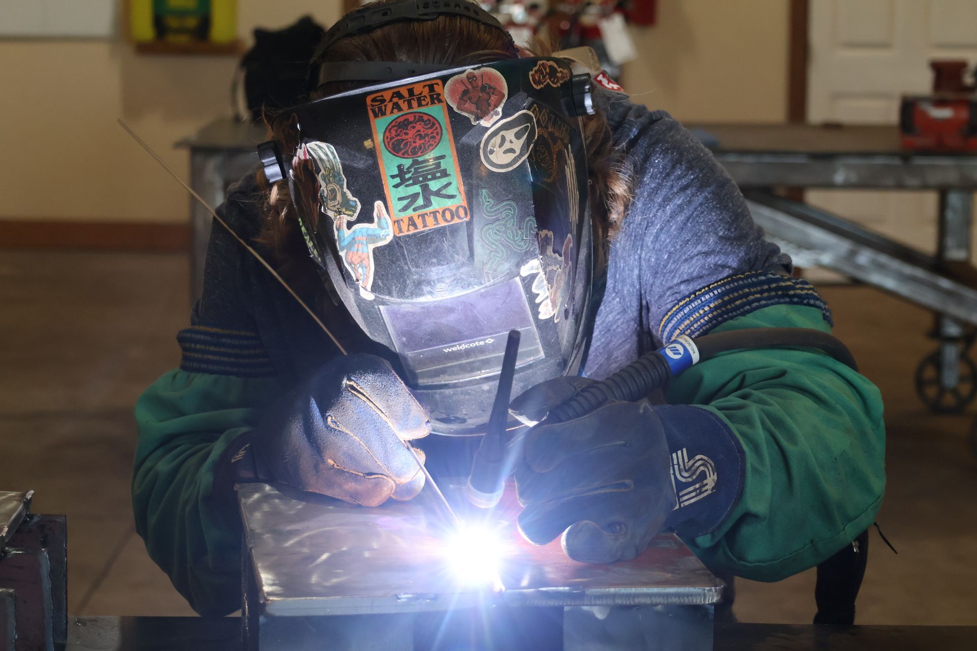 Welder performing on-site welding services on a marine vessel for Mills Marine & Ship Repair, LLC