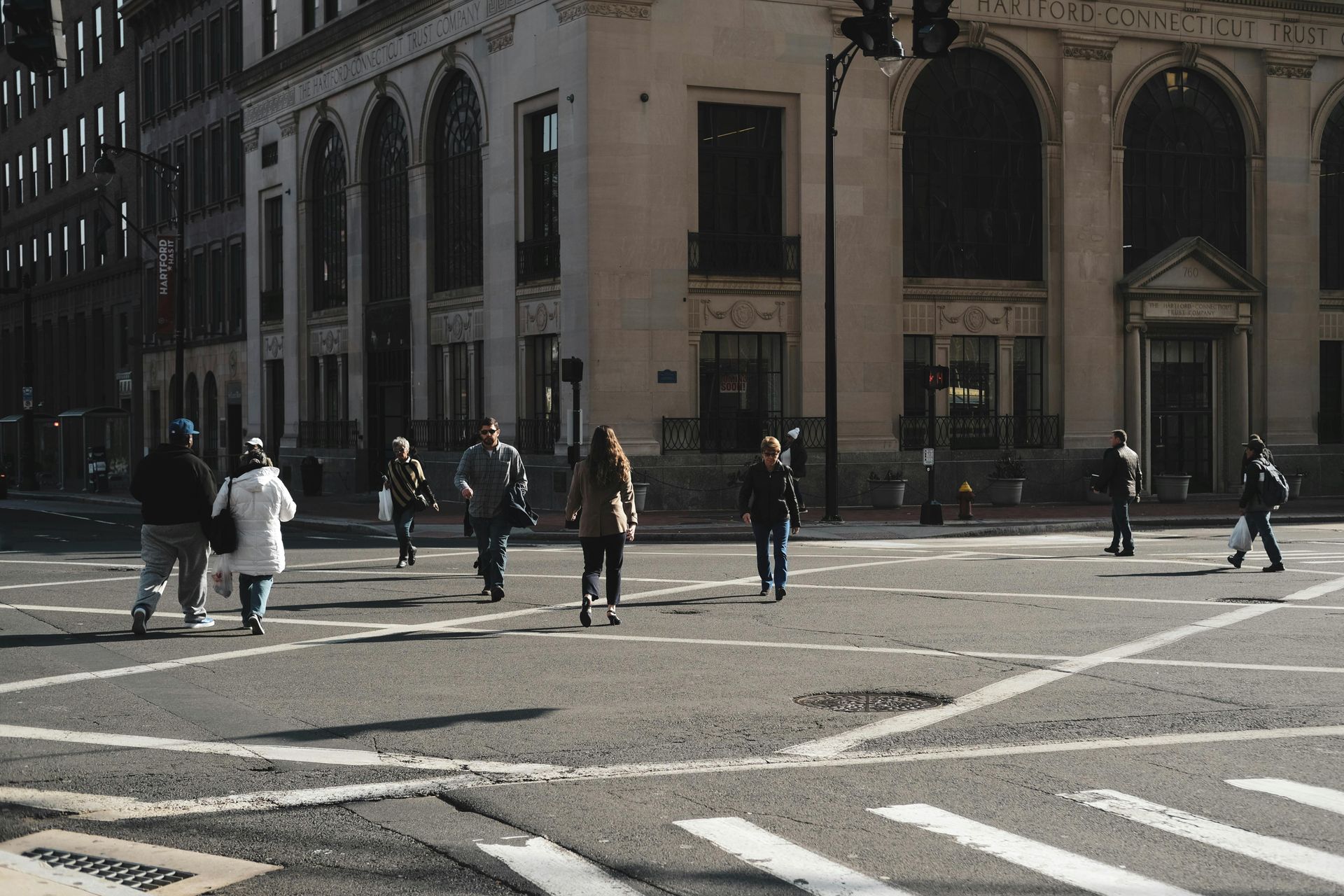 A woman is kneeling down next to a little girl.