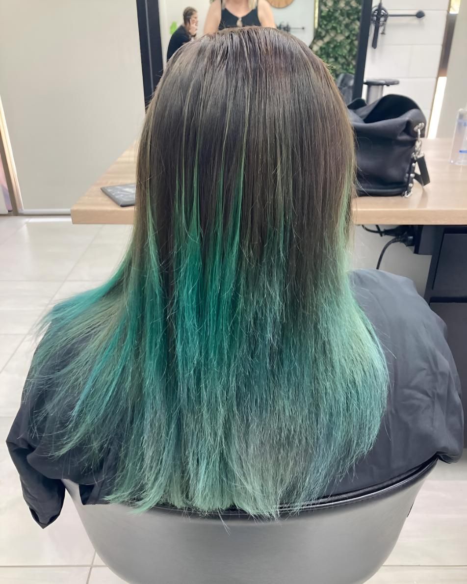 A Woman With Green Hair Is Sitting — Beautique Hair Lounge & Beauty Bar In Condon, QLD