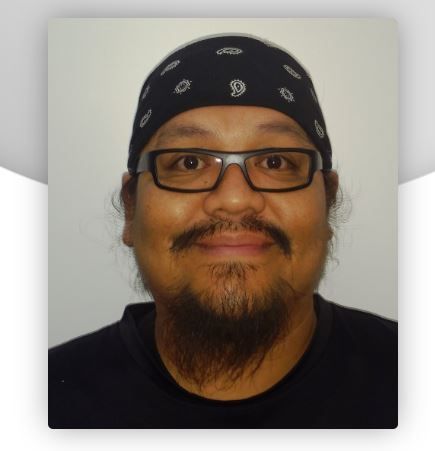 A man with glasses and a bandana on his head