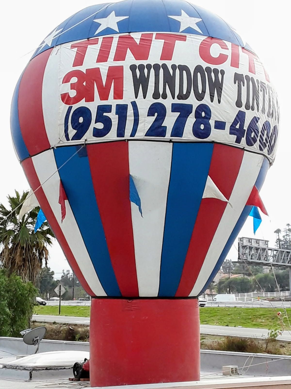 A red white and blue hot air balloon advertising 3m window tinting