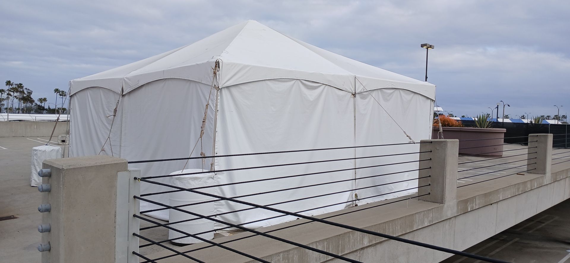 A white tent is sitting on top of a bridge.