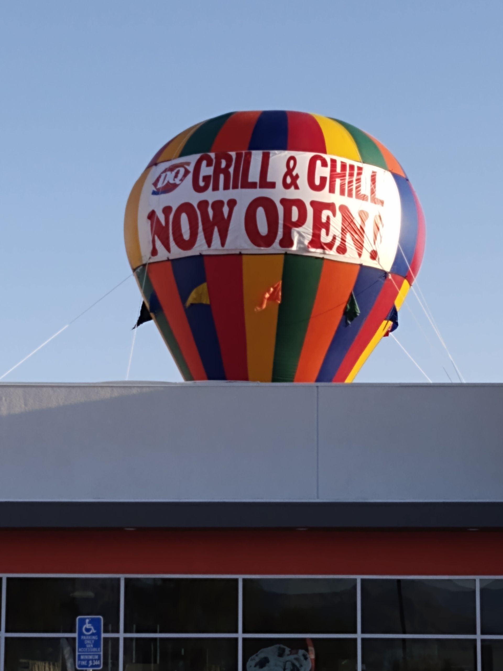 A hot air balloon that says grill & chill now open