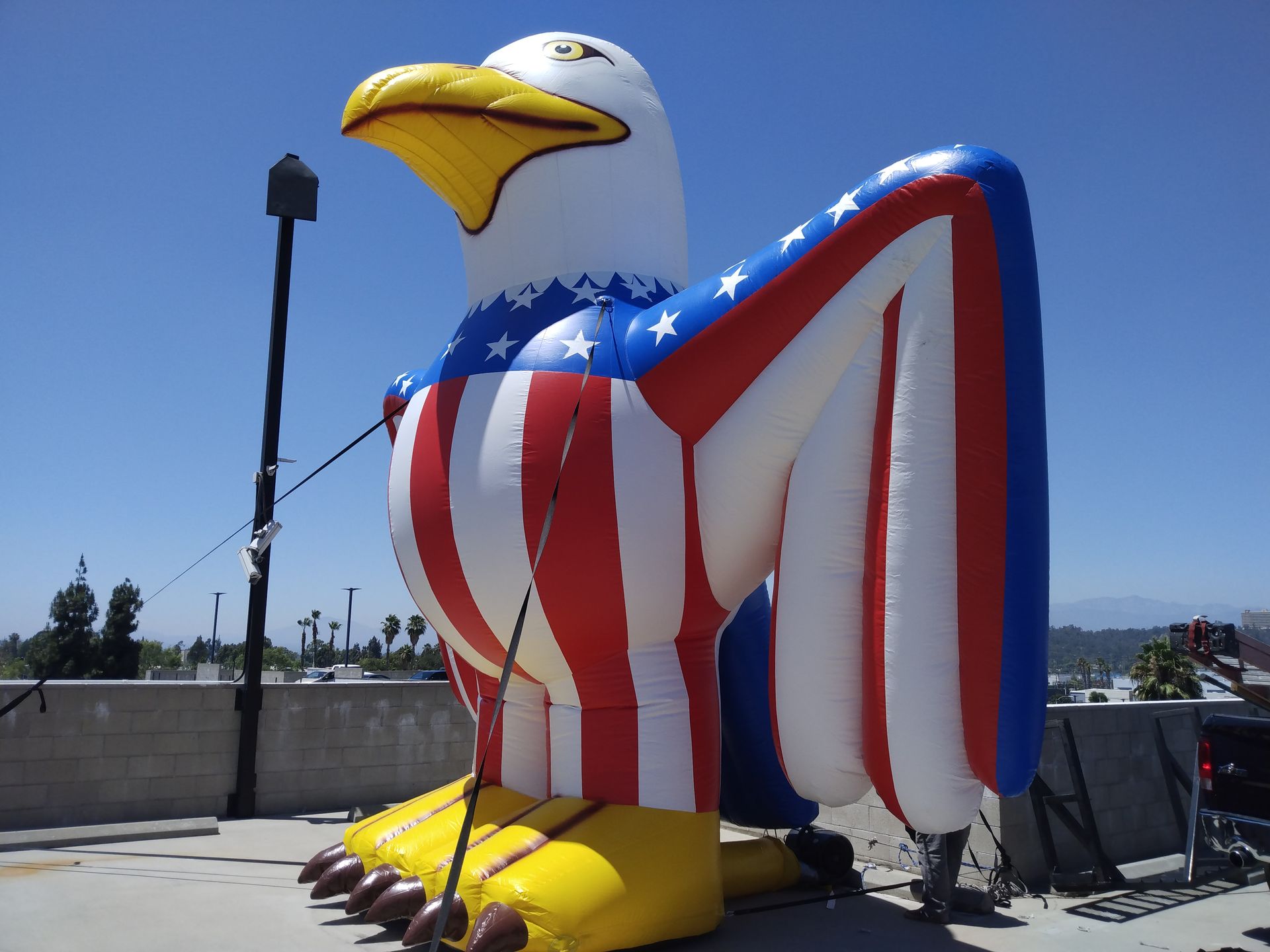 An inflatable bald eagle with an american flag on its wings
