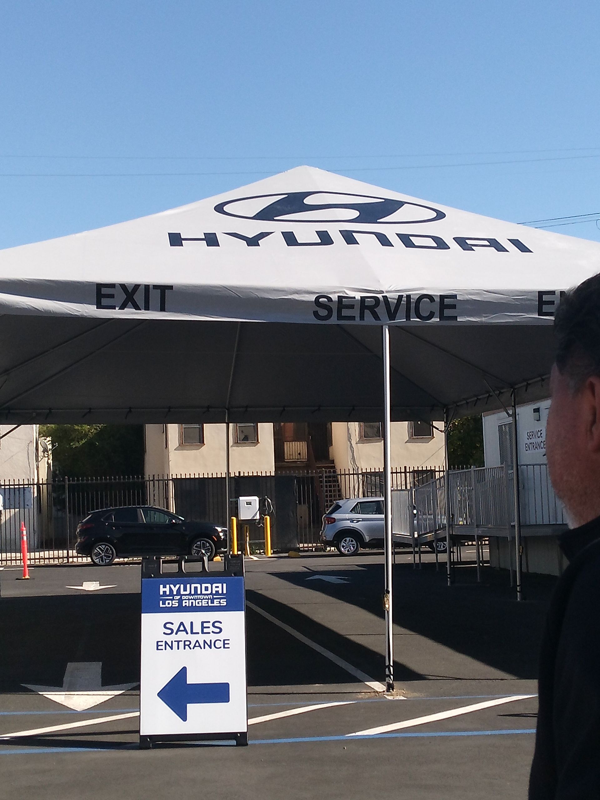 A man stands in front of a hyundai tent