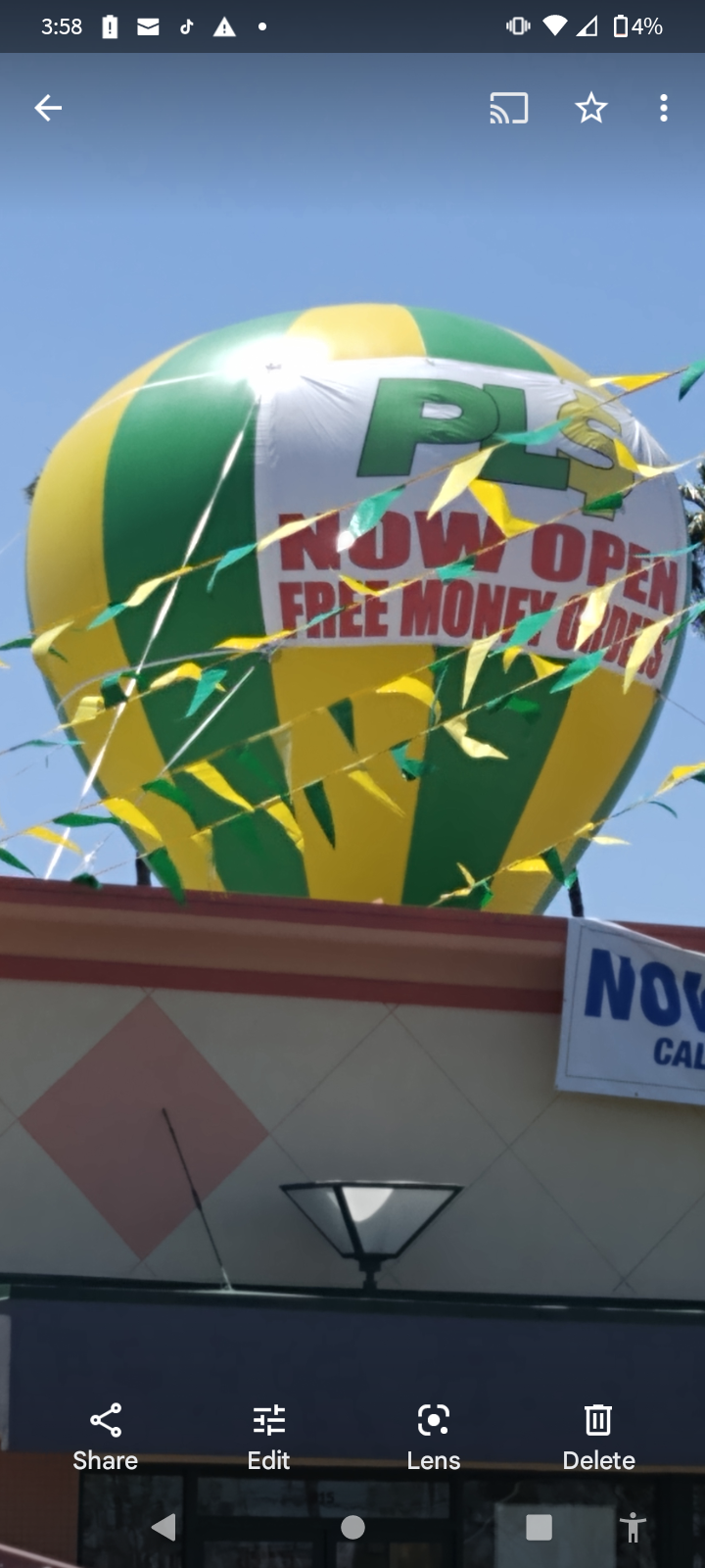 A yellow and green hot air balloon says now open free money day