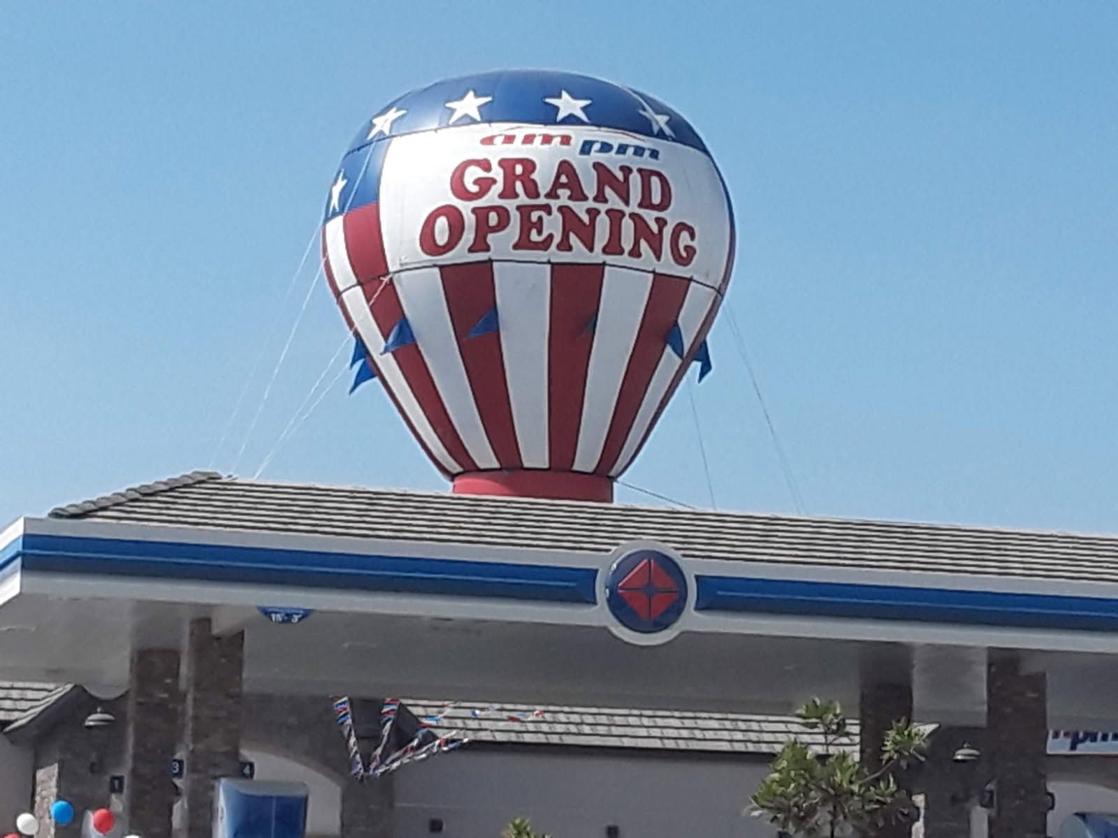 A hot air balloon with the words grand opening on it
