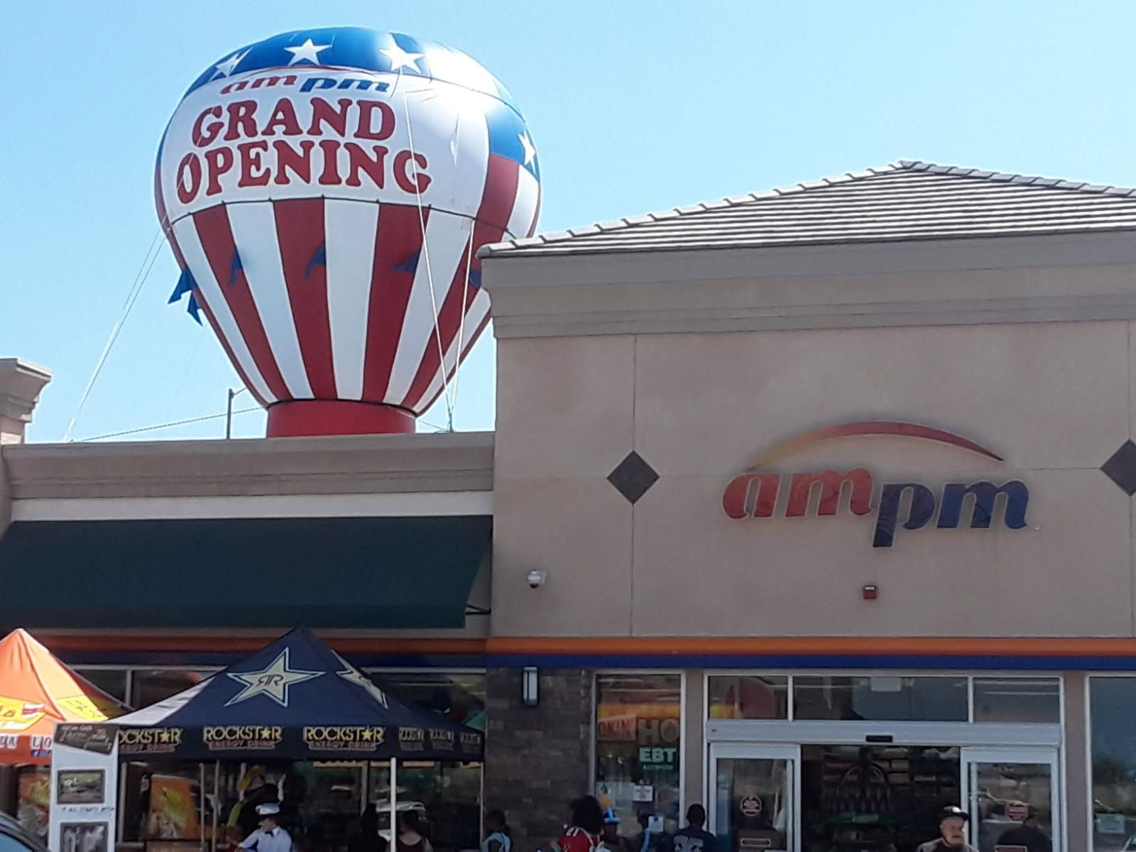 A store front with a hot air balloon that says grand opening