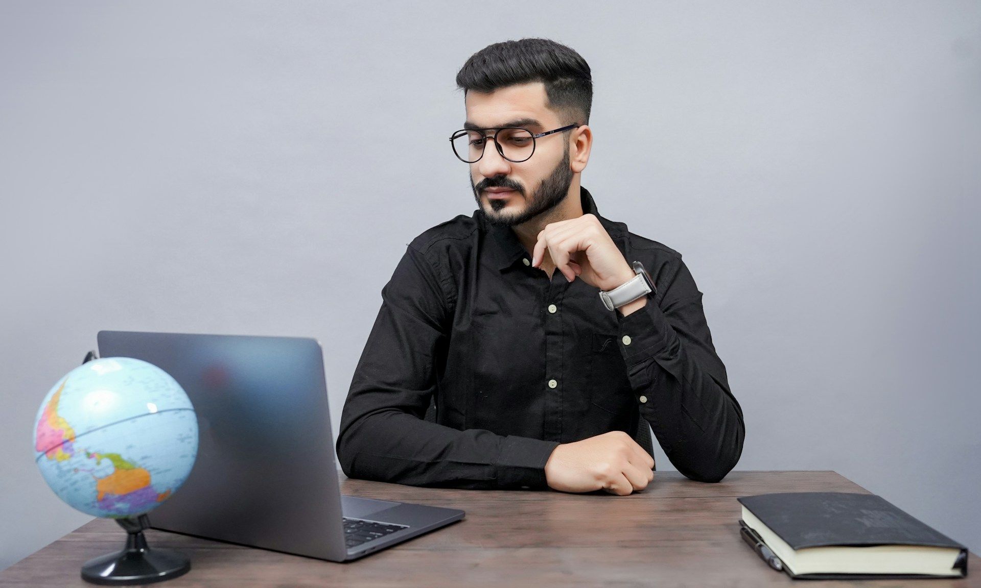 man looking at his laptop