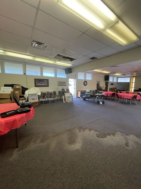 A large room with tables and chairs in it