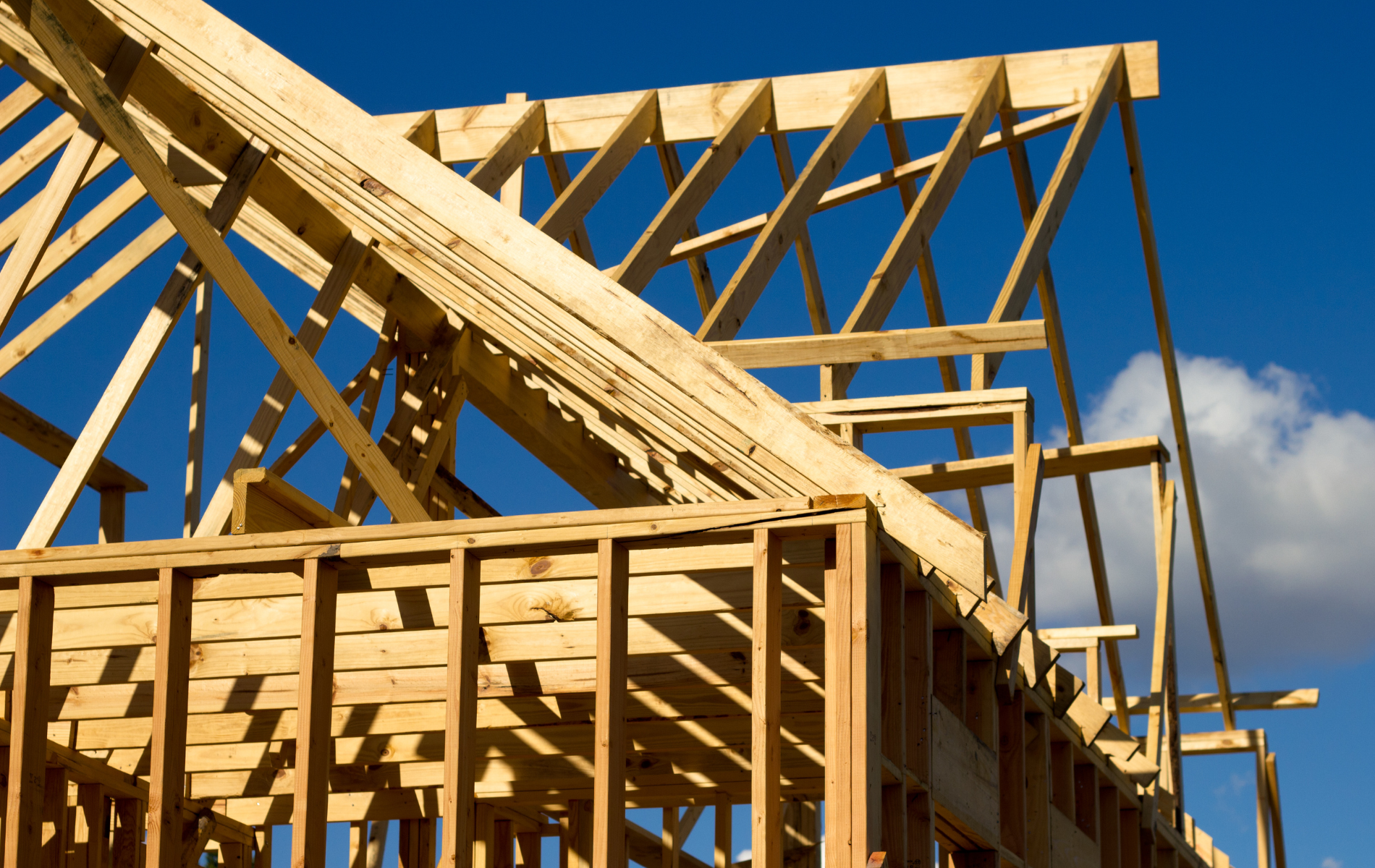 A house under construction with a blue sky in the background