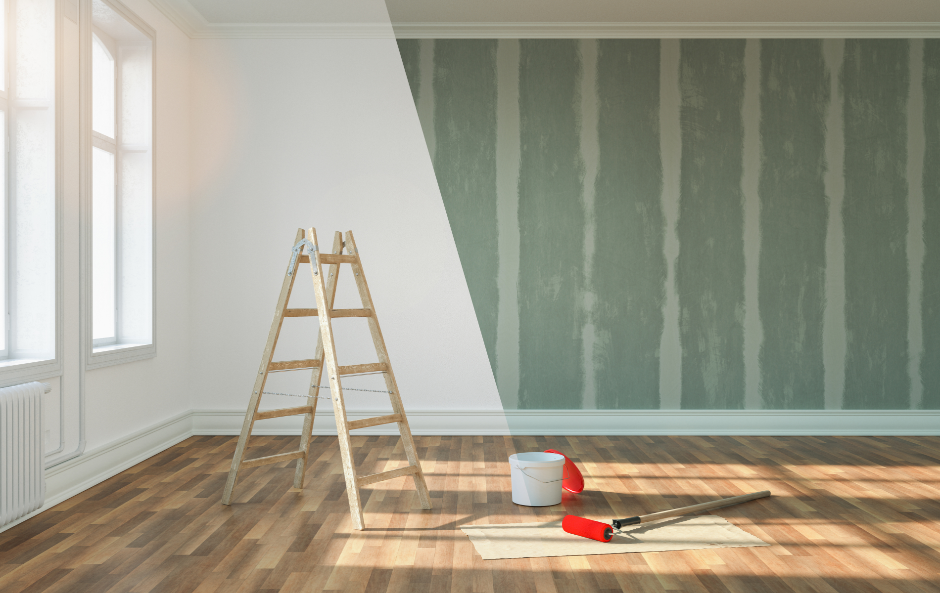 An empty room with a wooden ladder and a bucket of paint.