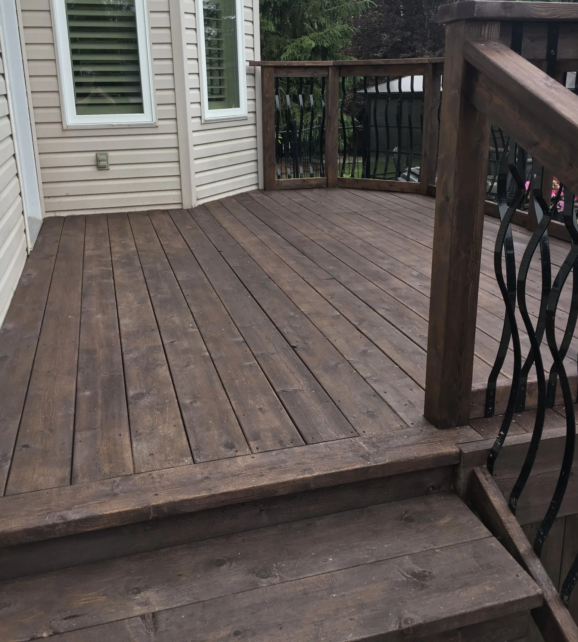 Deck stained with dark brown semi transparent stain