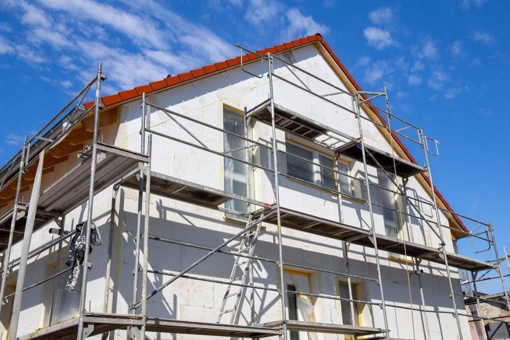 Expert Exterior Painting Services. House exterior being painted. With scaffolding on the outside.