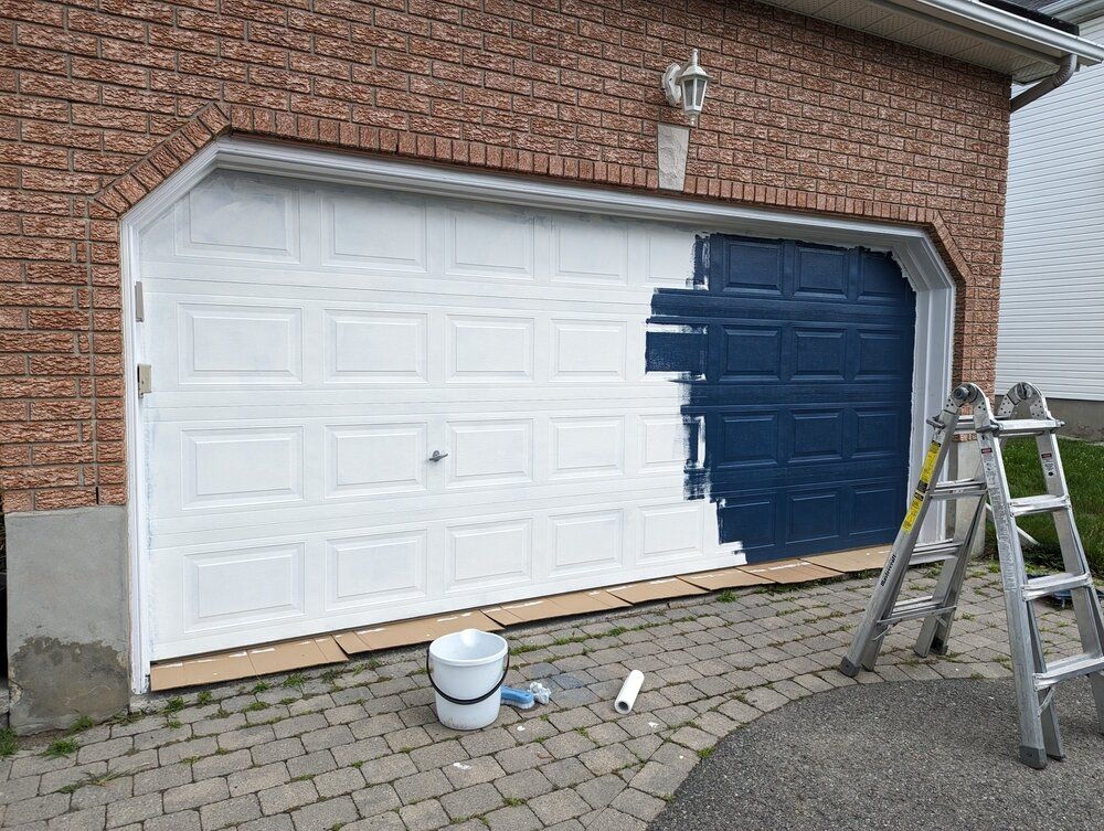 Exterior Painting. The garage door is partially painted. Blue to white.