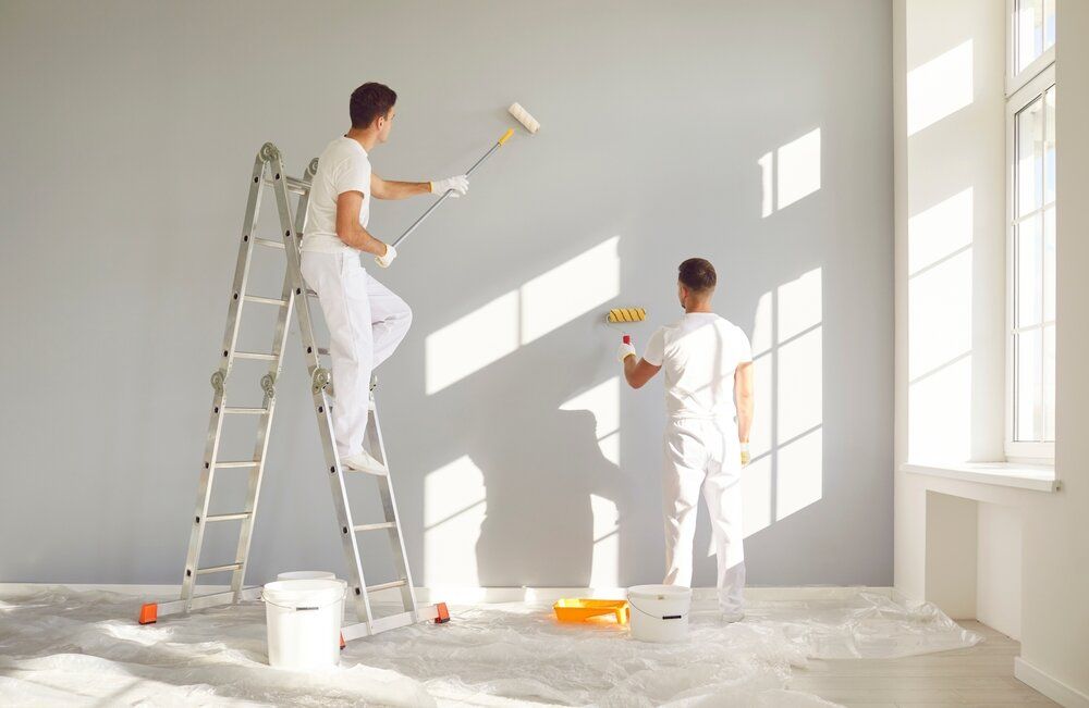 Painting Company in Ottawa. Two professionals painting a room white.