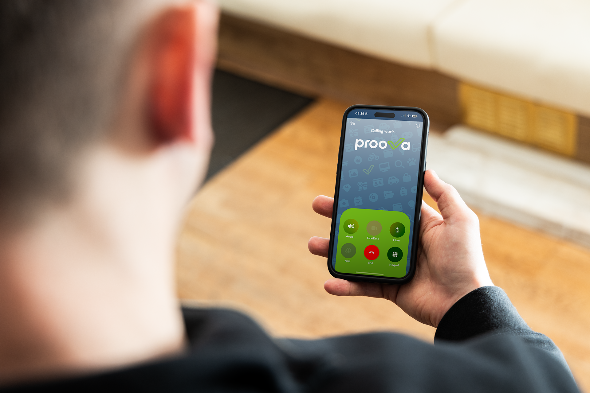 A man is holding a cell phone in his hand.