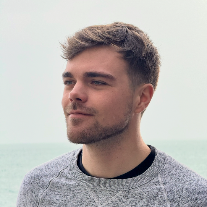 Man smiling in front of sea