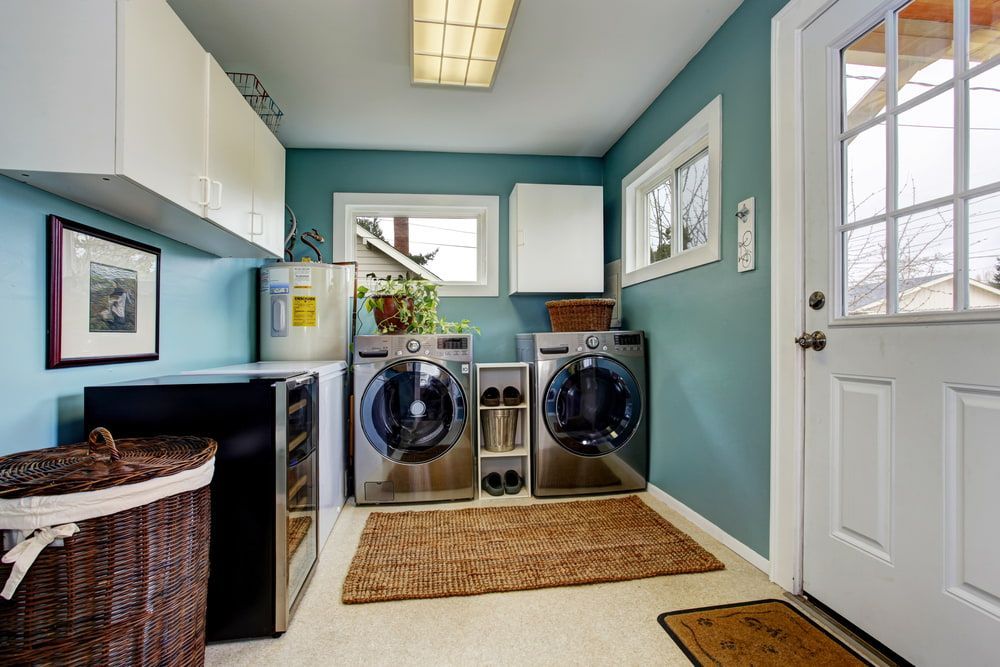 A Laundry Room With Two Washers And Two Dryers — CBY Carpentry & Renovations In Dubbo, NSW