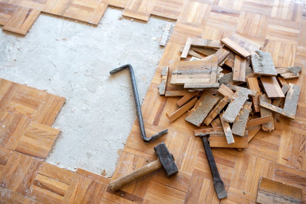 A Pile Of Wooden Blocks And Tools On A Wooden Floor — CBY Carpentry & Renovations In Dubbo, NSW