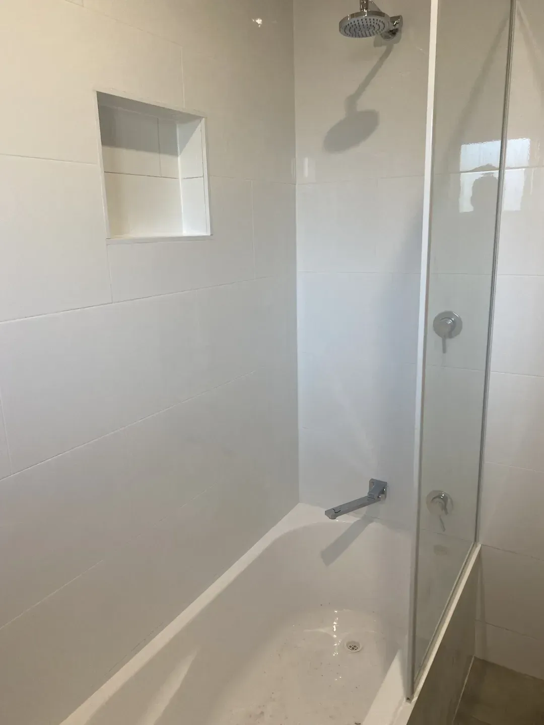 A bathroom with a bathtub and a shower stall. 