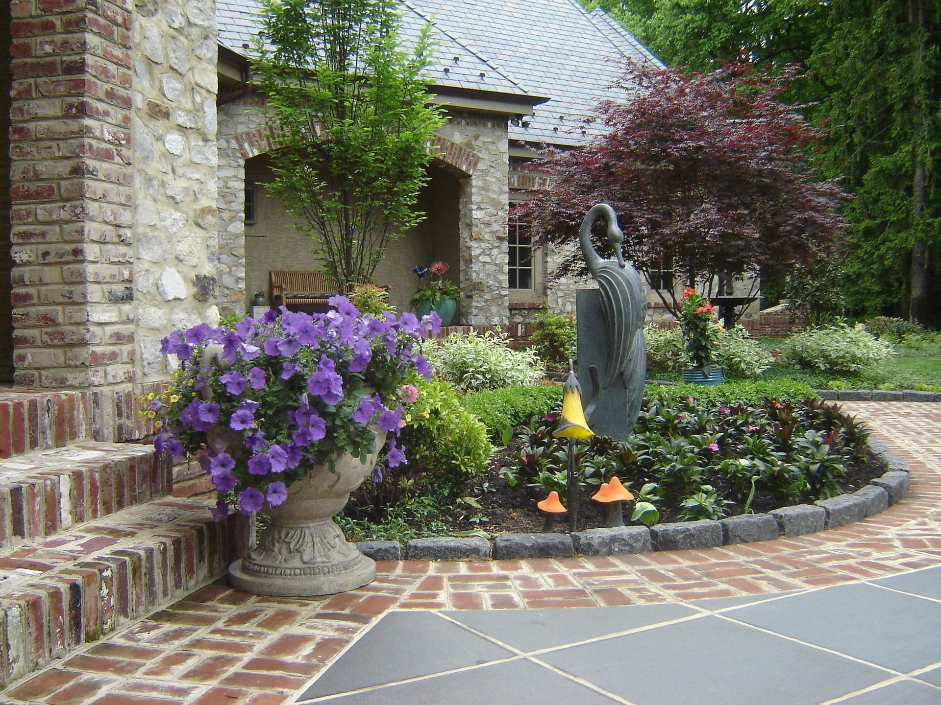 A Stone Patio with a Stone Building— Kennett Square, PA — Classic Lawns