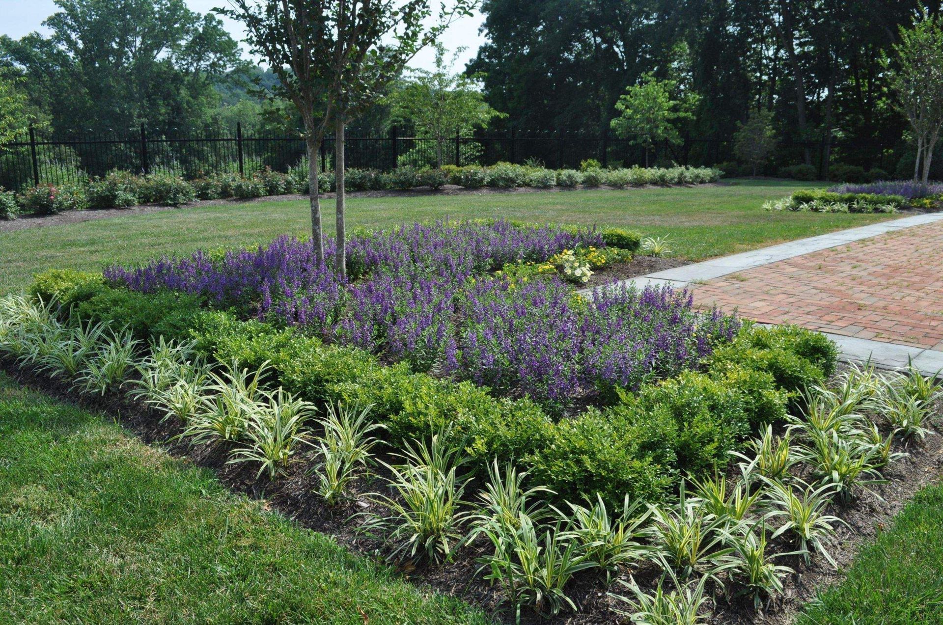 A Garden with a Brick Walkway — Kennett Square, PA — Classic Lawns