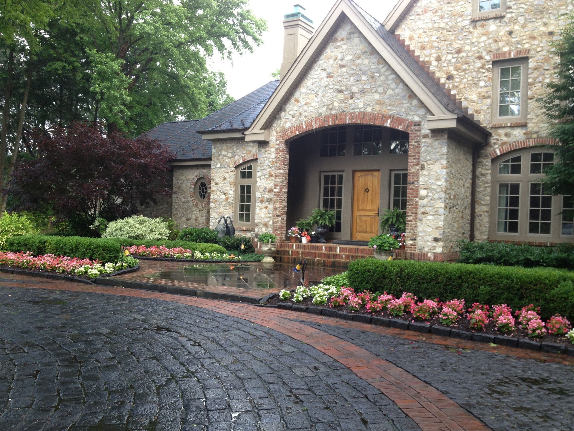 A Brick Driveway with a House and Flowers — Kennett Square, PA — Classic Lawns
