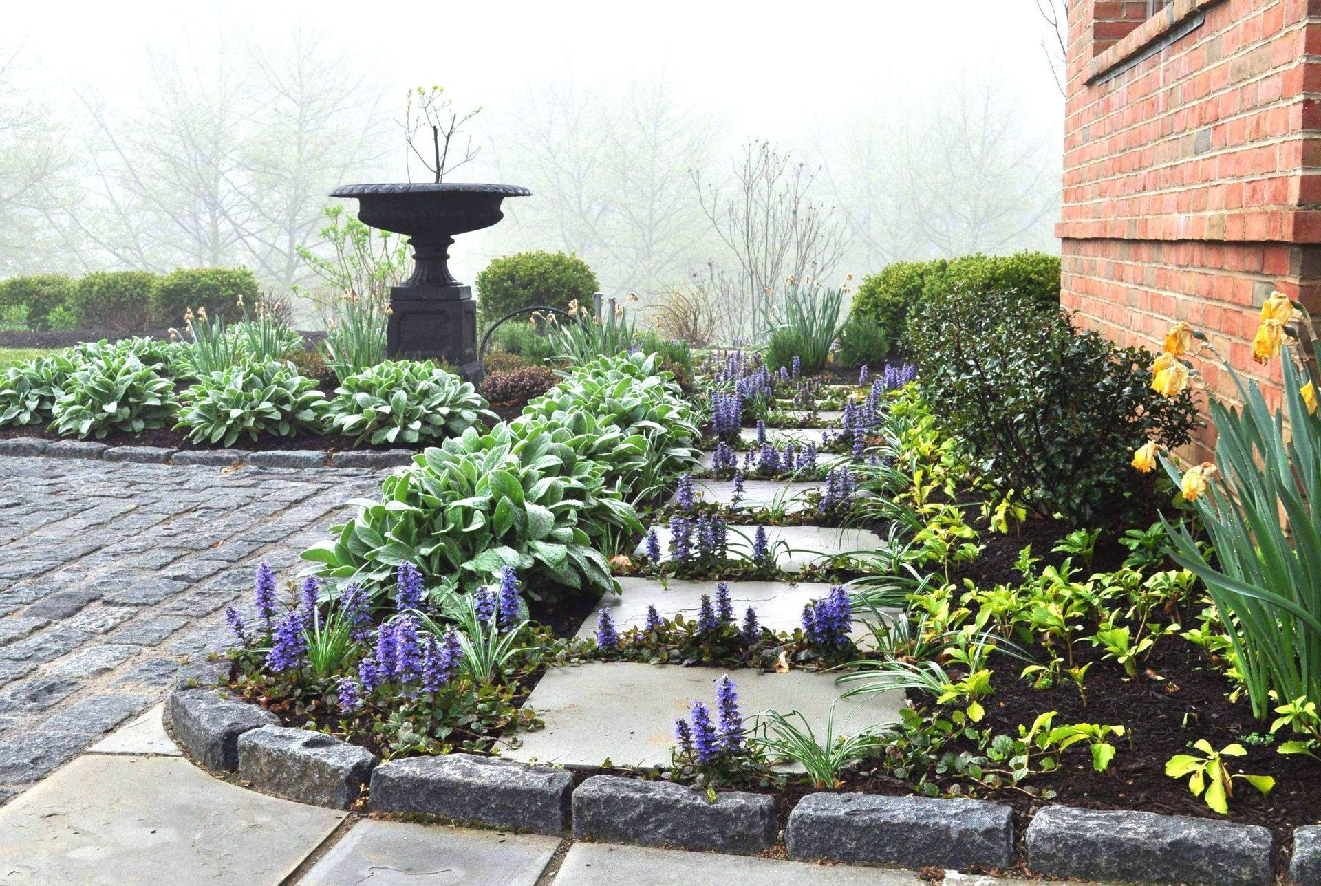 A Garden with Plants and a Fountain— Kennett Square, PA — Classic Lawns