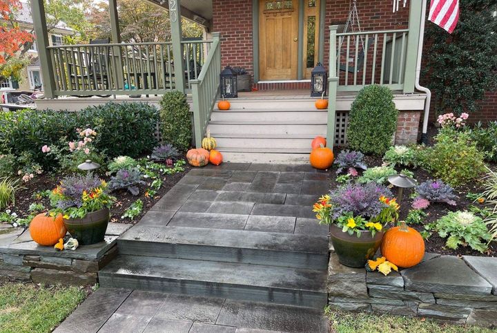 A Front Porch of a House with a Staircase and Pumpkins — Kennett Square, PA — Classic Lawns