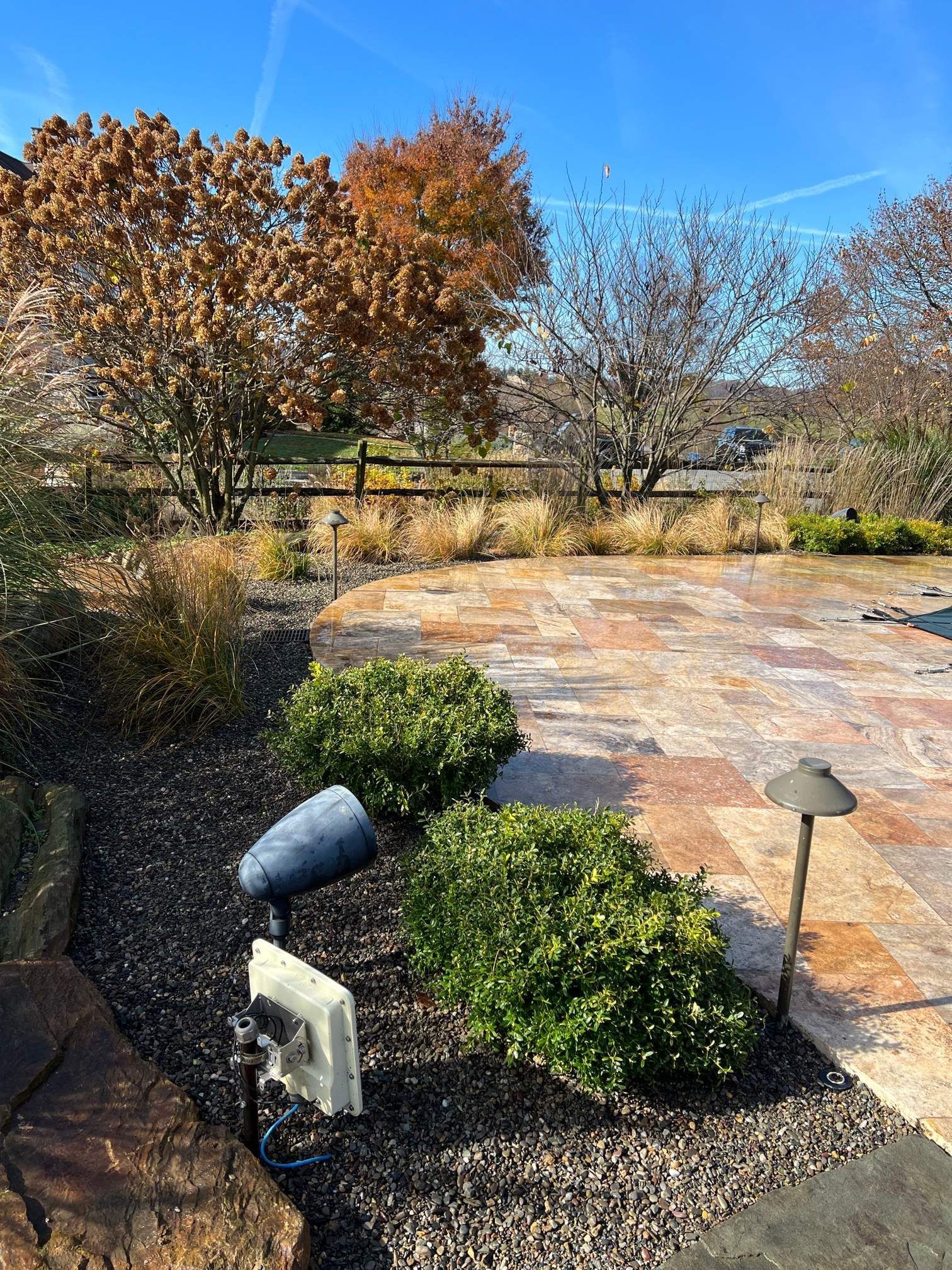 A Stone Patio with a Light and Bushes — Kennett Square, PA — Classic Lawns