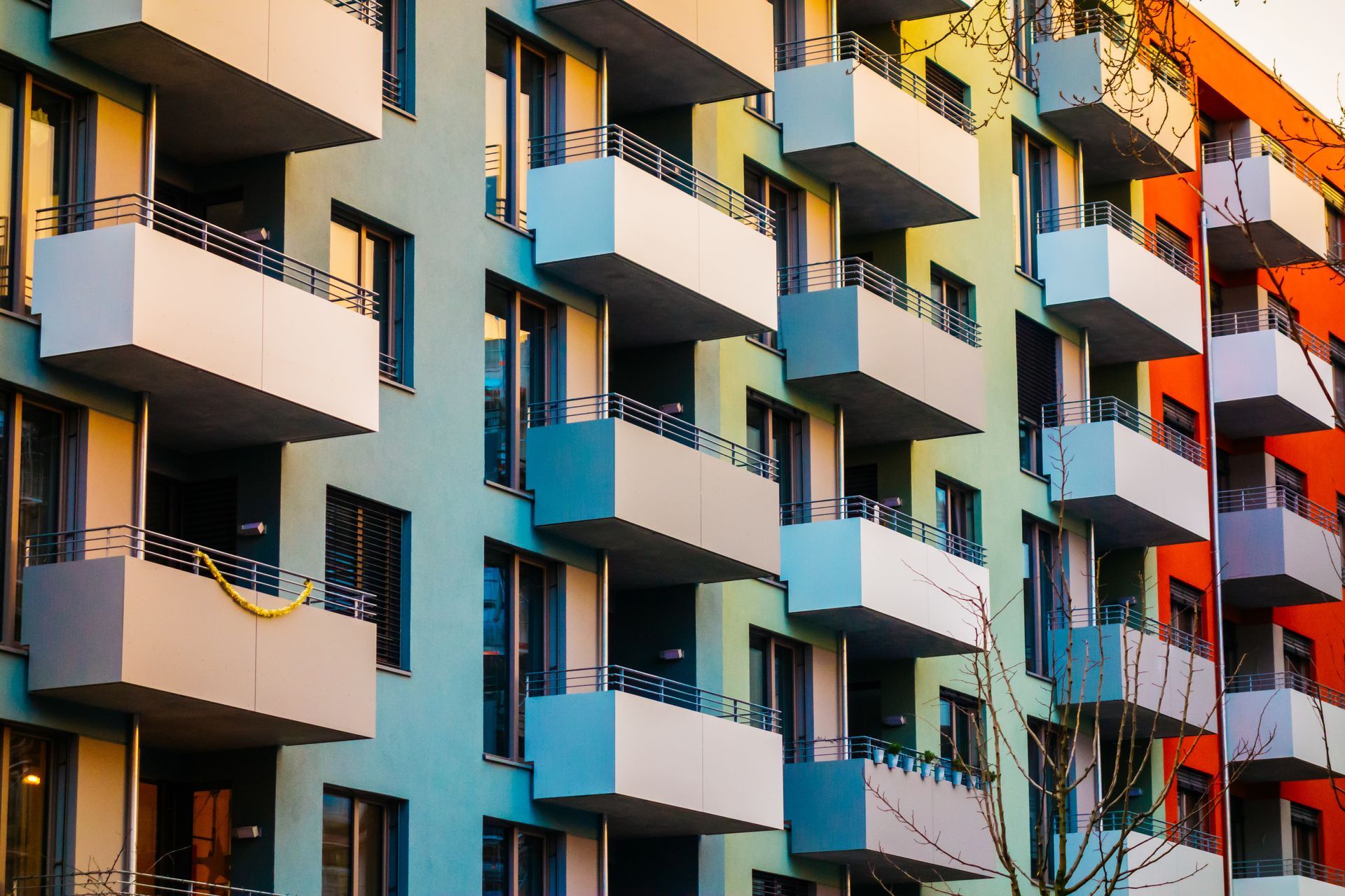 A colorful apartment building with many balconies and windows