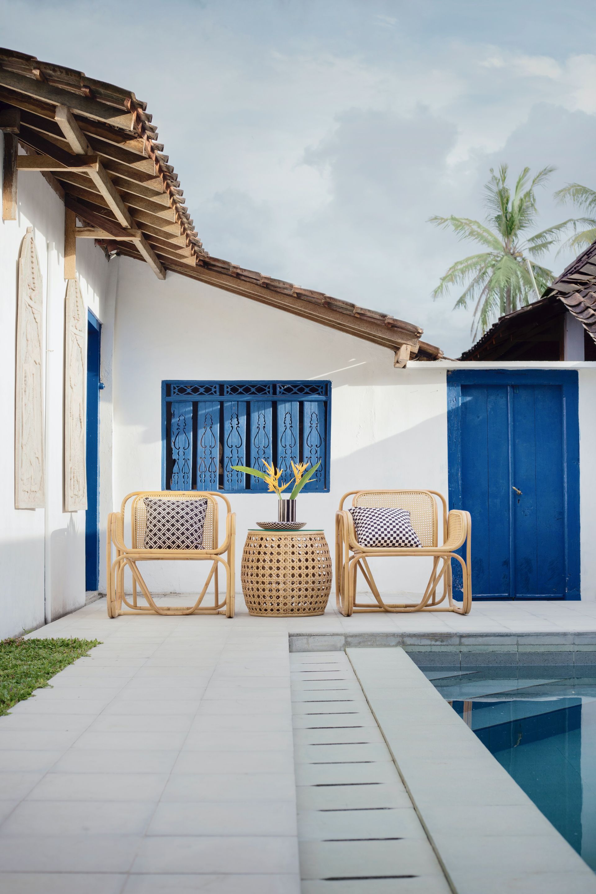 A white house with blue doors and a swimming pool