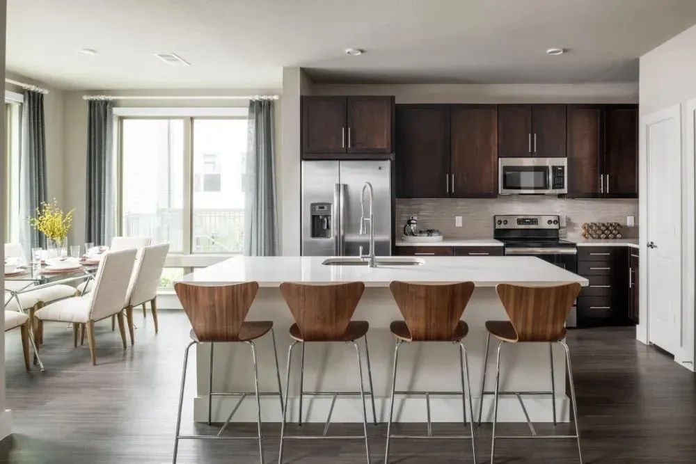 Modern kitchen with spacious island and dining area.