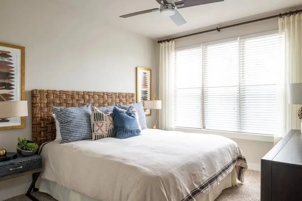 Cozy bedroom with a woven headboard and decorative pillows