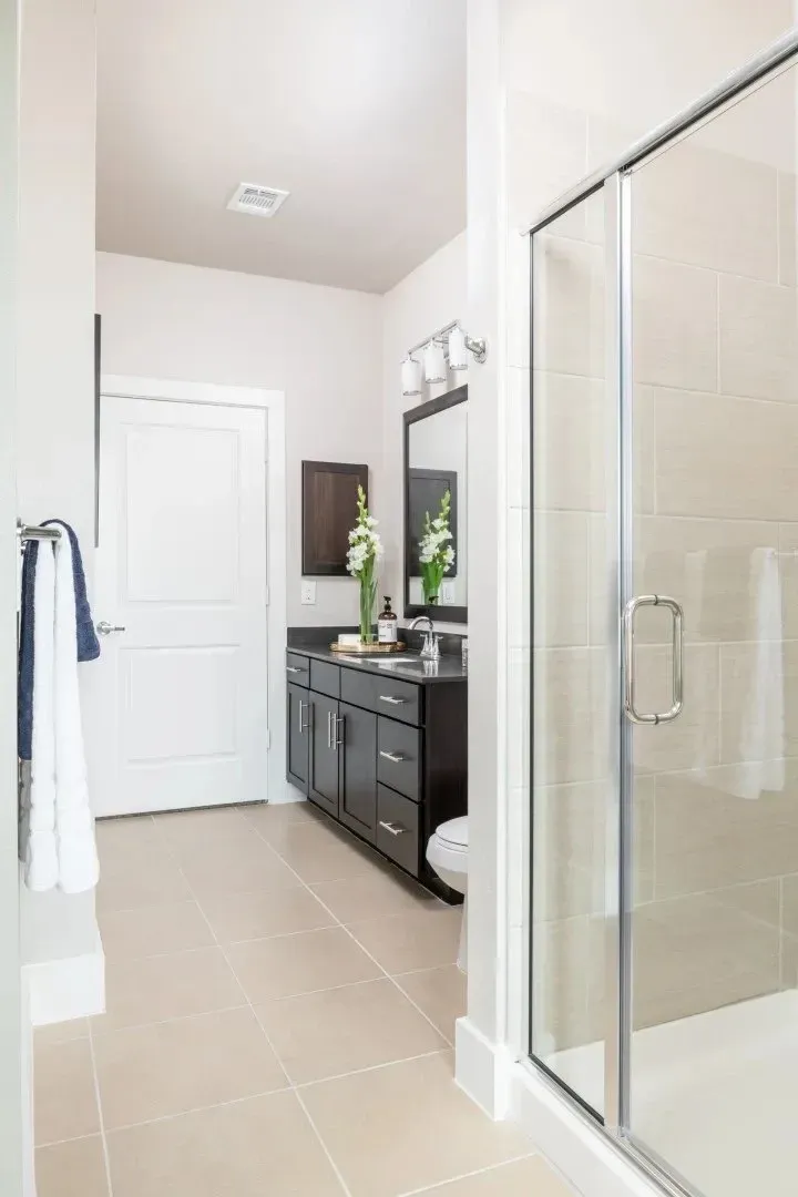 Modern bathroom with a shower, sink, and cabinetry