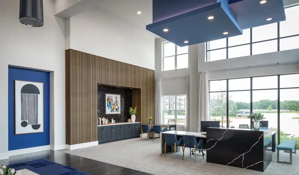 Modern lobby area with large windows and seating.