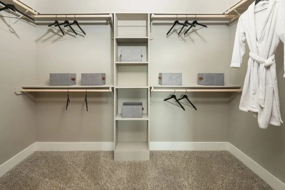 Spacious walk-in closet with shelves and hanging space.