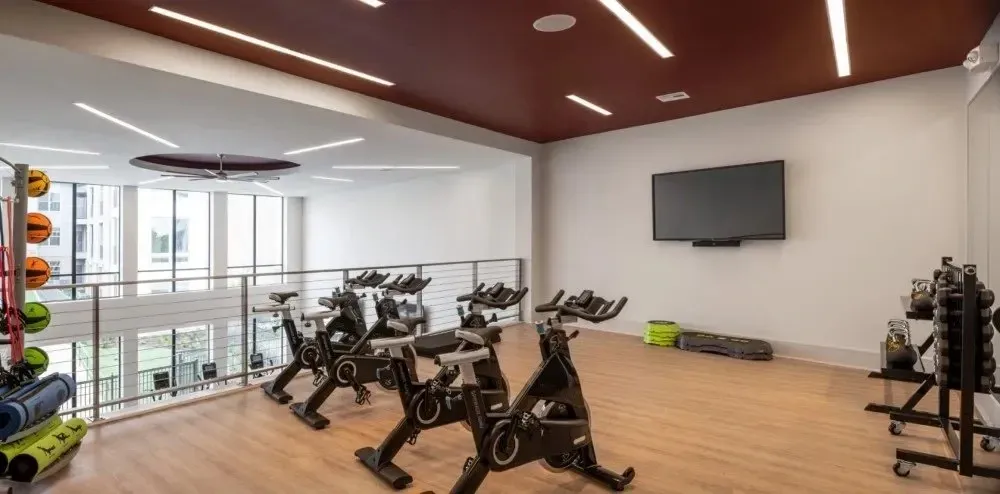 Interior view of a fitness room with stationary bikes and exercise equipment