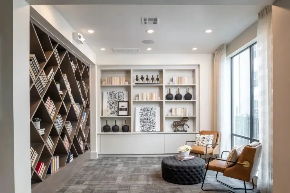 Stylish community lounge area with bookshelves and seating