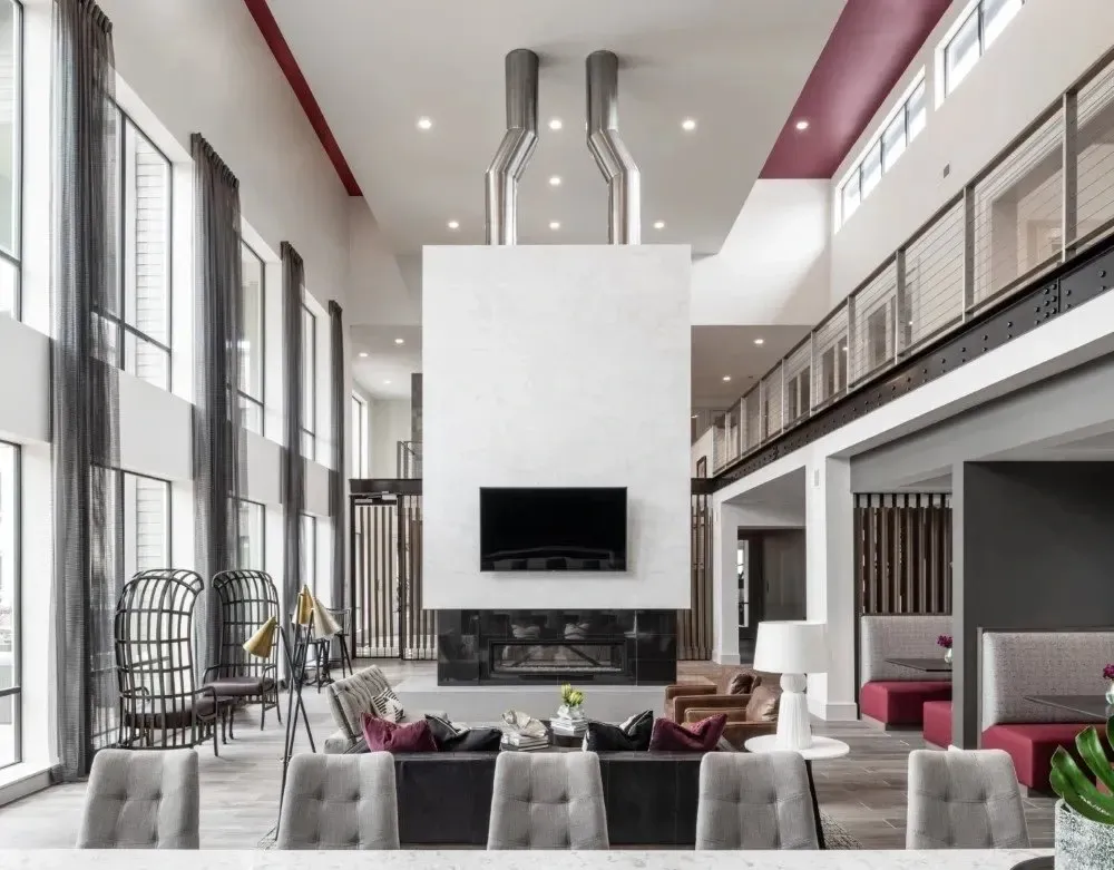 Stylish community lounge area with seating and large windows