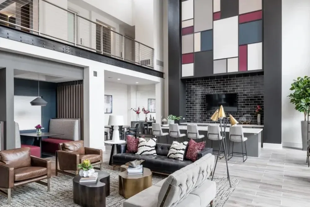 Modern lounge area with seating and a kitchen bar