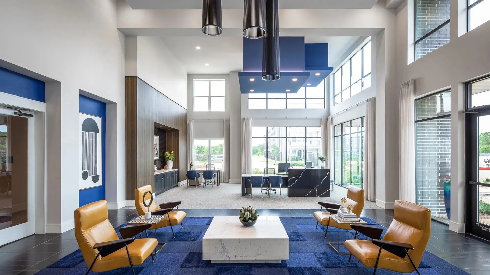 Modern lobby area with seating and large windows.