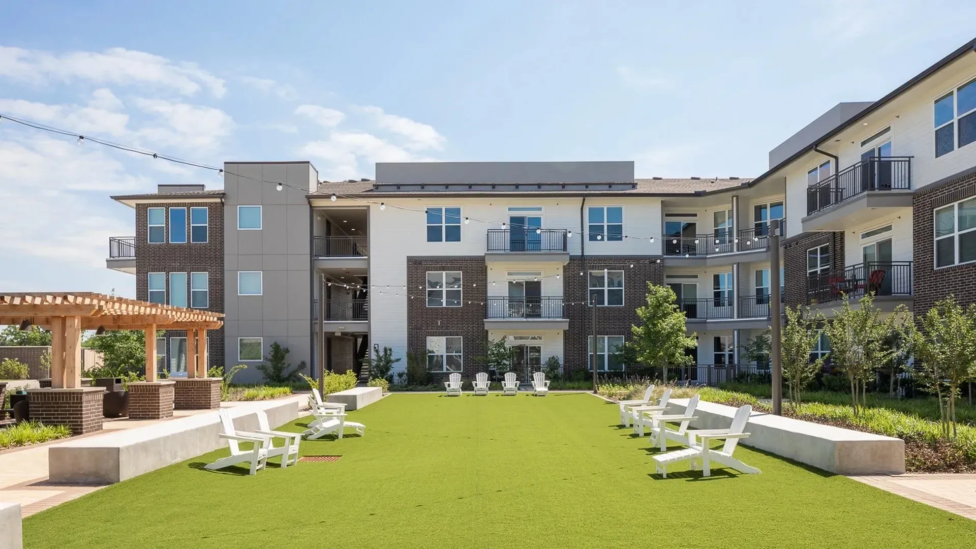 Outdoor area with seating and greenery near residential buildings