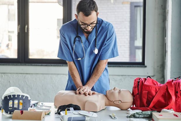 A nurse is practicing a heart attack on a mannequin.