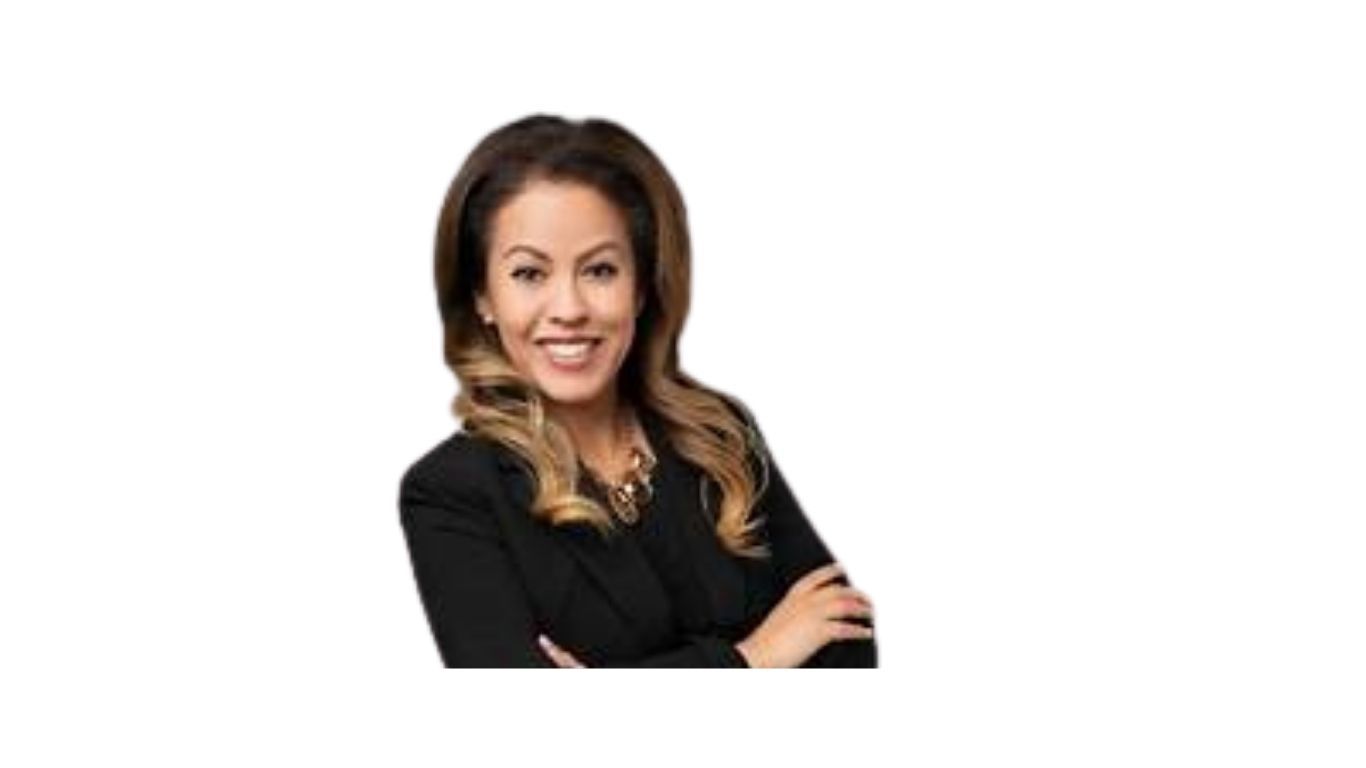 A woman in a black suit with her arms crossed