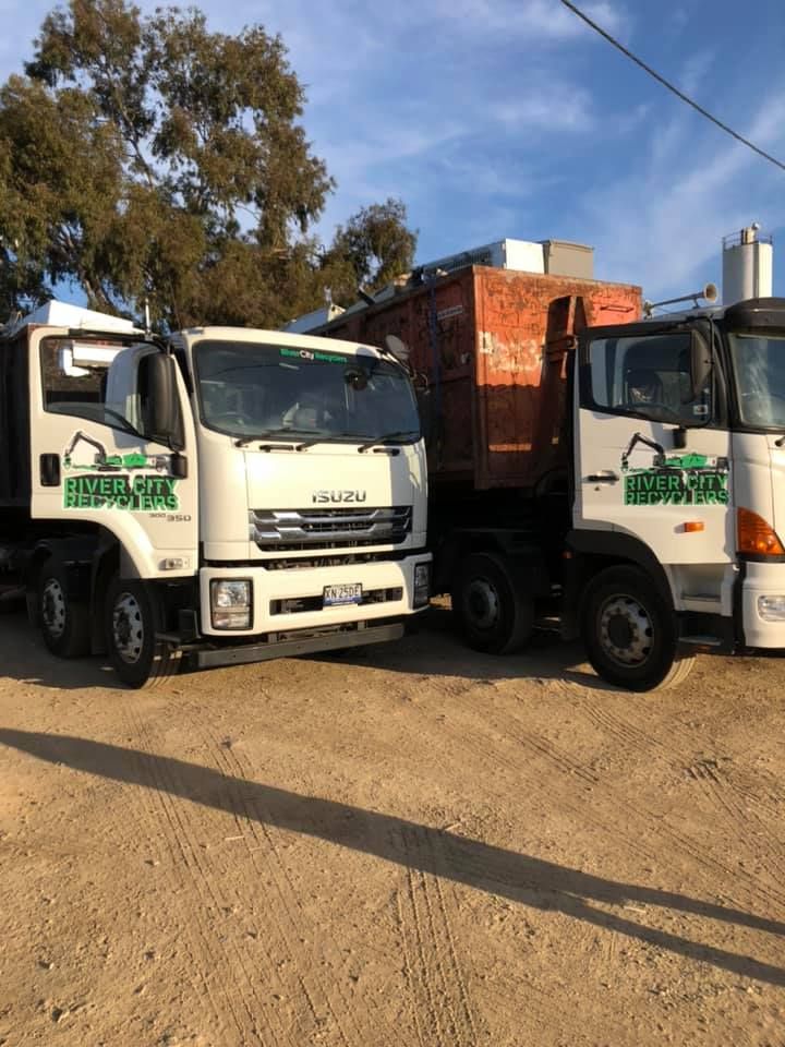 Two Dump Trucks Are Parked Next To Each Other — RiverCity Recyclers In Port Macquarie, NSW