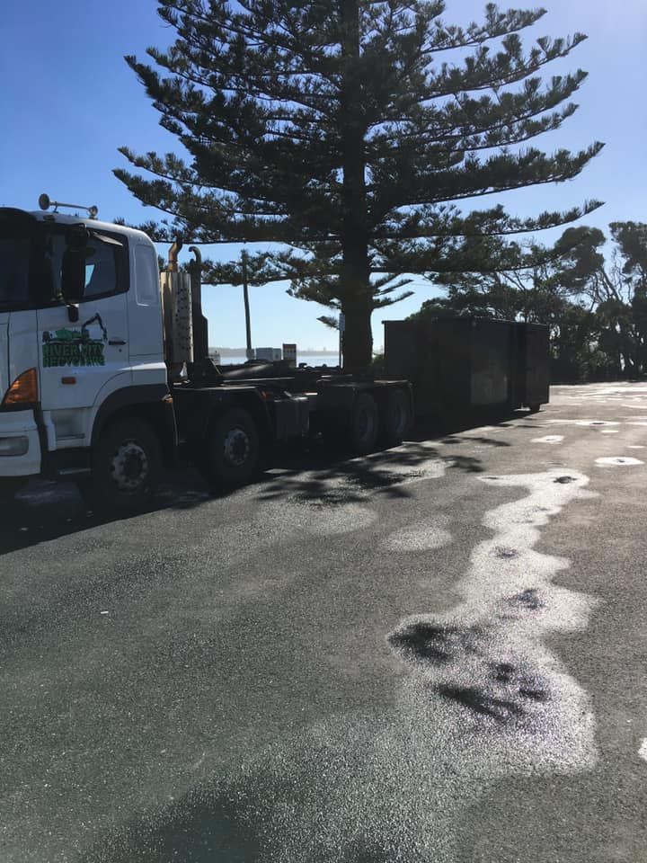 A Truck Is Parked On The Side Of The Road Next To A Tree — RiverCity Recyclers In Taree, NSW